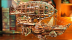 Sailing In Fog steampunk airship displayed on a bookshelf, a laser cut wooden model kit for adult hobby collectors