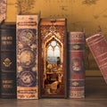 Sailing Memory book nook kit lit between real books, a maritime tavern diorama with a sea-view window for shelves