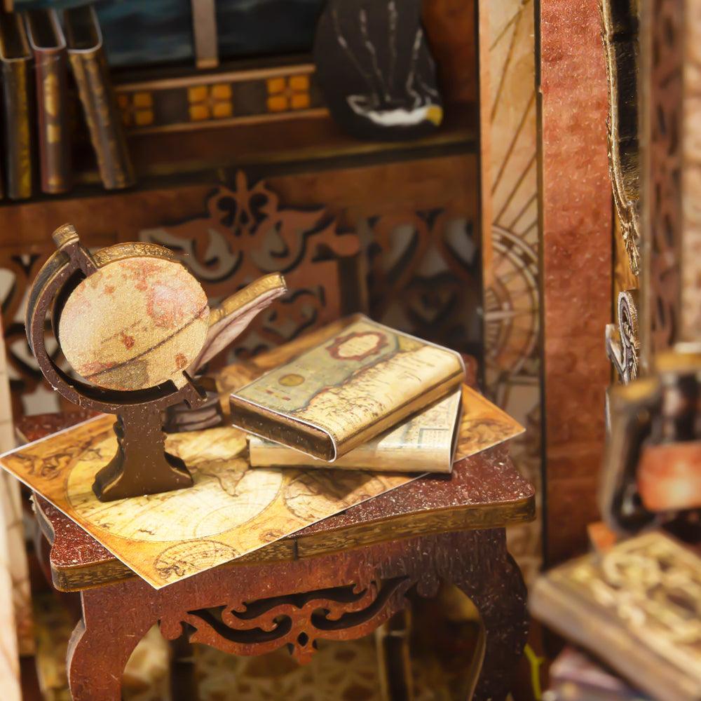 Old-world globe and antique sea maps on a carved table, a nautical miniature book nook kit for map and history fans