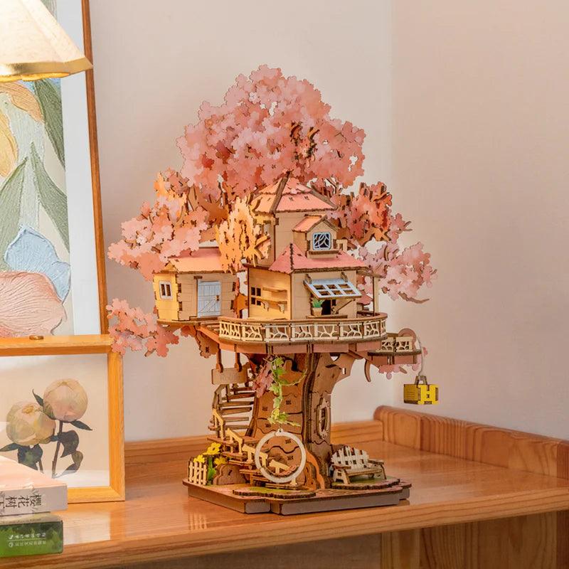 Two-story treehouse wooden model with a wraparound balcony and spiral staircase, a sakura puzzle for hobby model builders