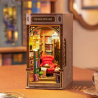 Assembled Shakespeare bookshop book nook on a desk with a red reading chair, a warm lit miniature display for readers