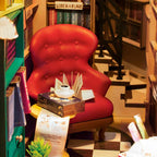 Elizabethan reading corner with a red velvet armchair and open folio, a lit Shakespeare book nook for book lovers