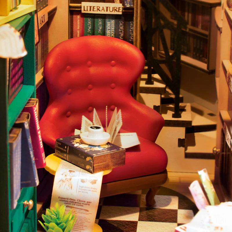 Elizabethan reading corner with a red velvet armchair and open folio, a lit Shakespeare book nook for book lovers