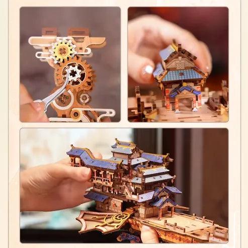Assembling the Sky Voyager wooden airship kit by hand, fitting numbered laser cut gears and pavilion roof pieces