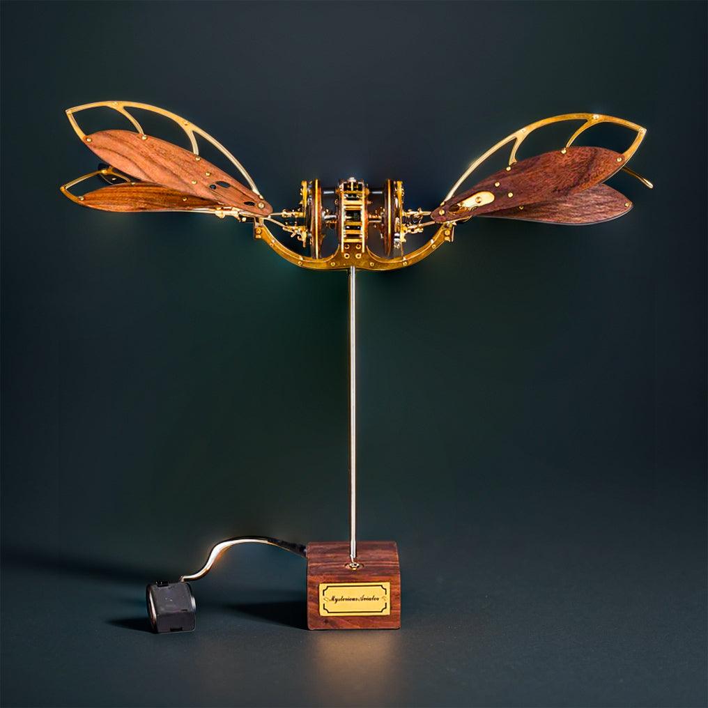 Kinetic 3D metal puzzle aircraft with motorized dragonfly wings as a mechanical desk sculpture and shelf centerpiece