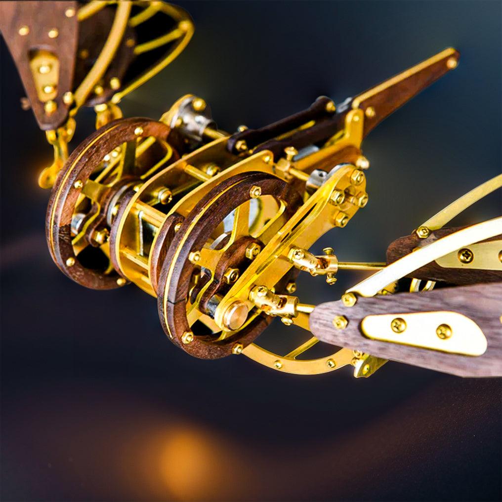 Dragonfly inspired motorized aircraft sculpture in laser cut brass and walnut for mechanical model building fans