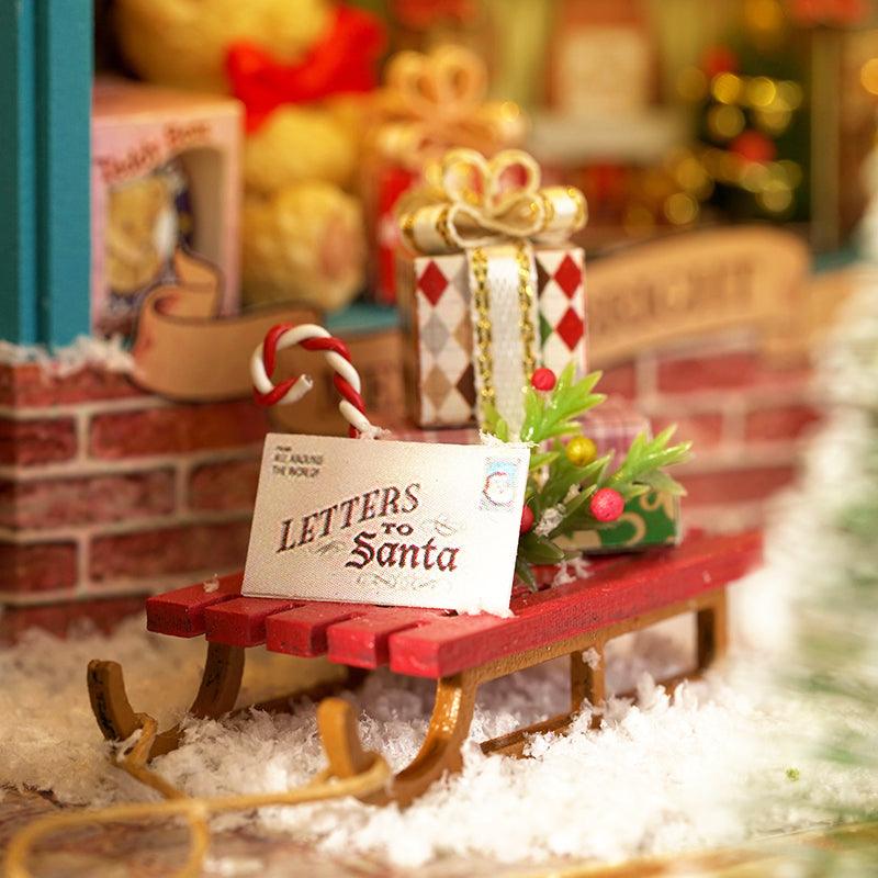 Festive toy shop miniature dollhouse detail with a tiny sleigh and wrapped gifts, an illuminated 1:24 wooden box holiday kit Dream Store