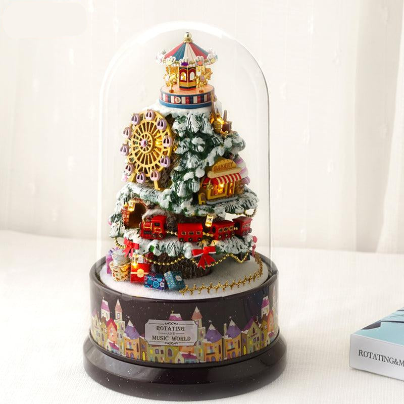 Snowy Christmas tree miniature kit finished under a glass dome with a carousel, Ferris wheel and train, a festive LED music box