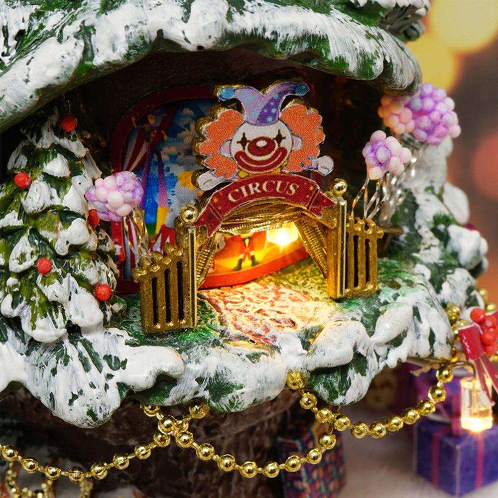 Illuminated circus archway with a clown and wrapped gifts on a snowy tree, a whimsical winter carnival miniature craft kit