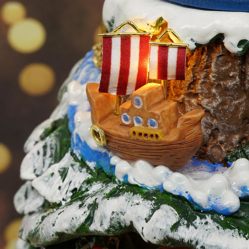 Little striped-sail boat riding a snowy blue stream on a festive Christmas tree scene, a holiday miniature building set for teens