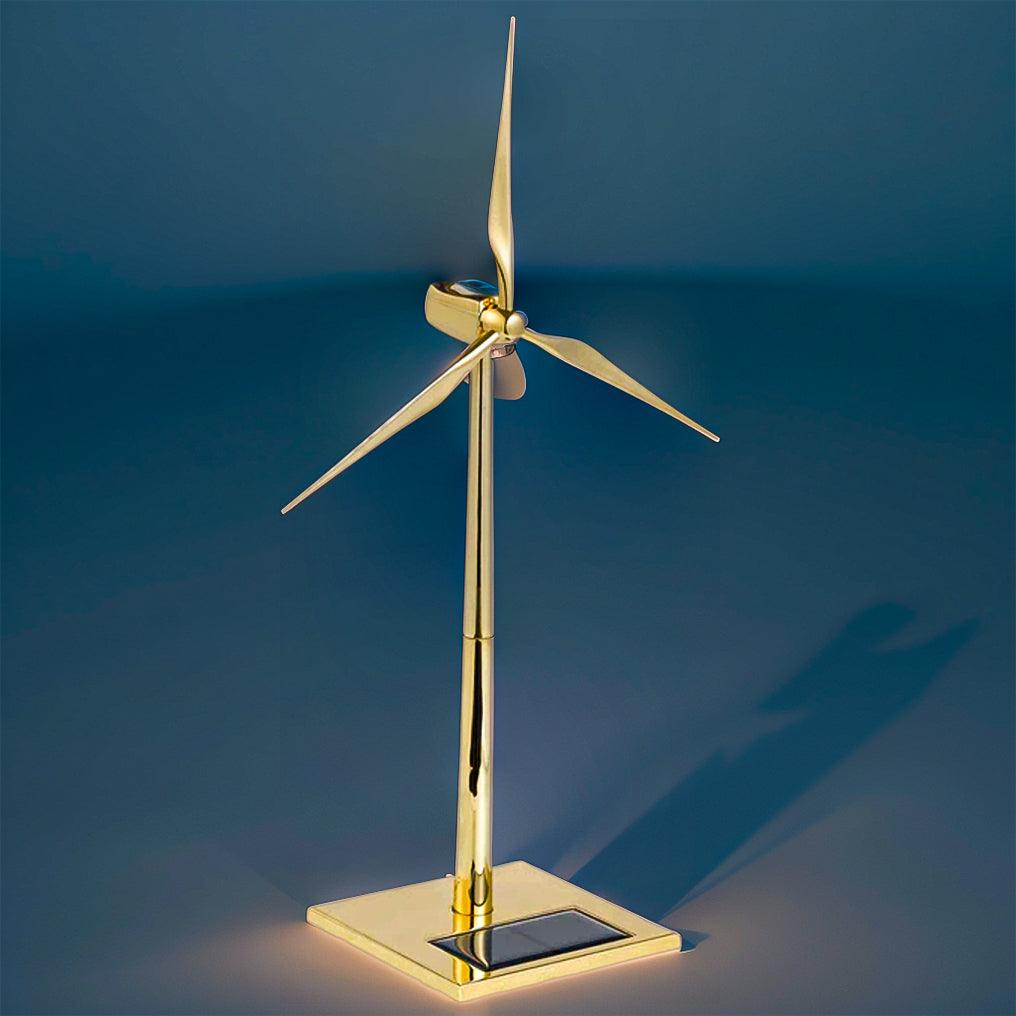Golden solar windmill sculpture displayed on a shelf, a kinetic wind turbine model that turns in daylight