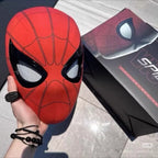 red spiderman mask with moving eyes held beside its costume box, halloween superhero cosplay mask for adults and comic con events SPIDERMAN-MK_RED_CHIN