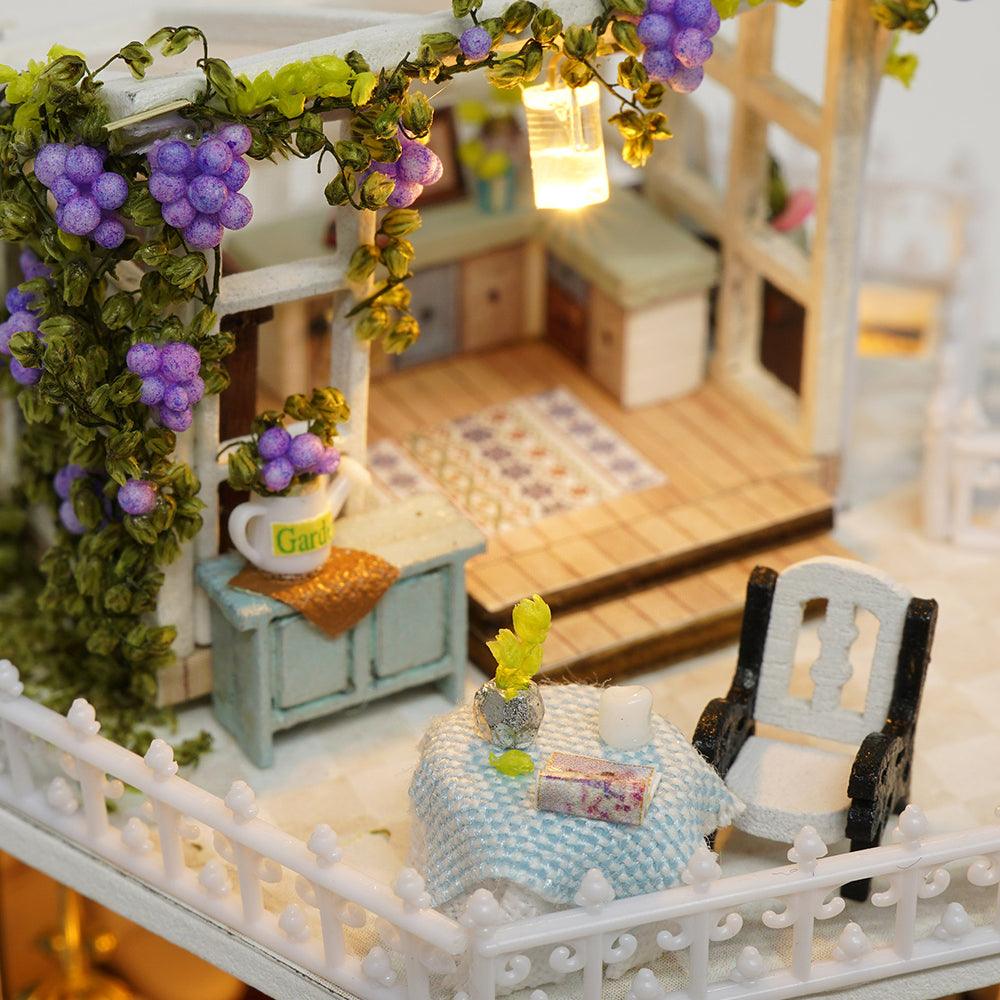Rooftop terrace garden with grapevines, a bistro table and lantern in a cozy 1:24 miniature dollhouse building kit