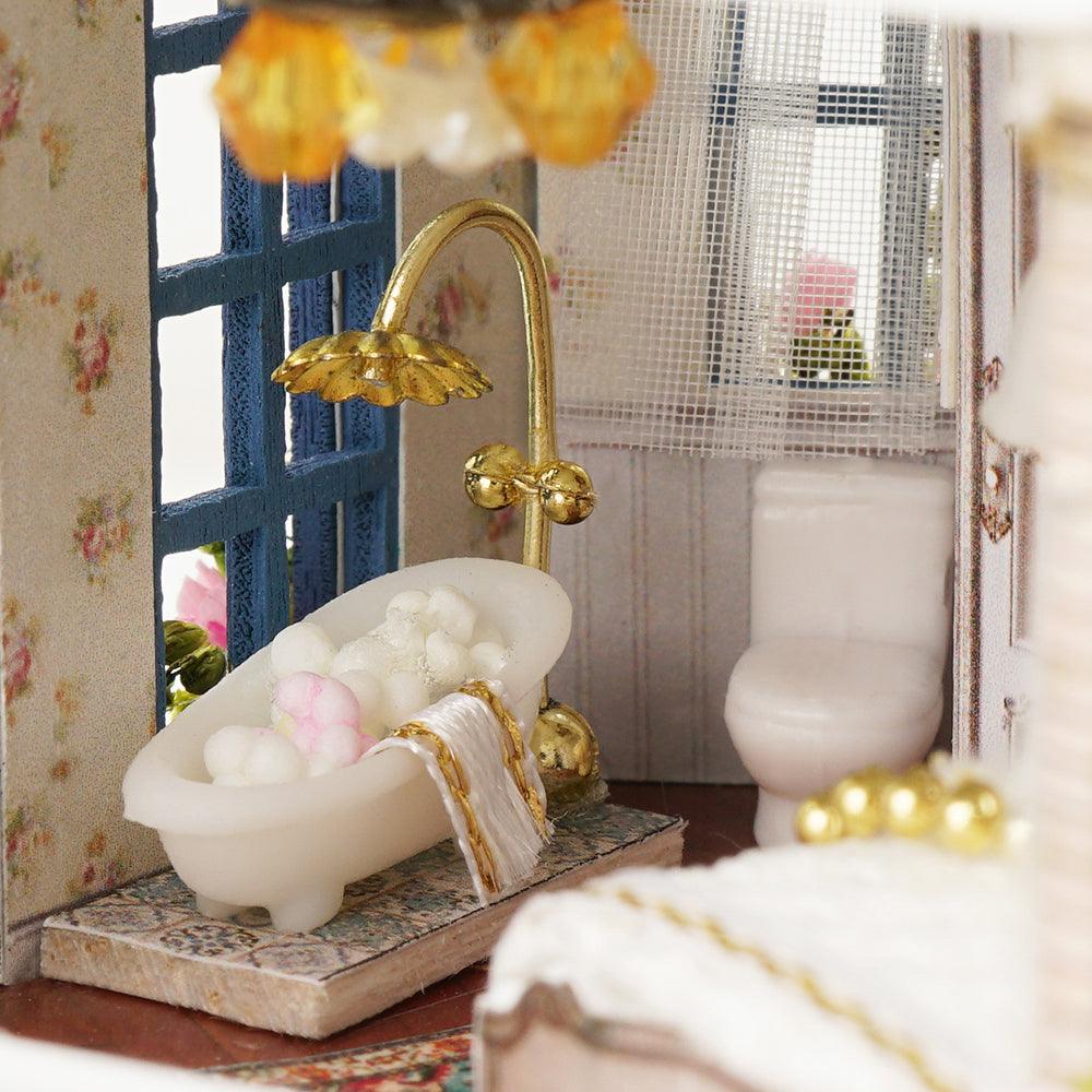 Miniature dollhouse bathroom with a clawfoot tub and gold fixtures, a relaxing craft gift for hobbyists ages 14 up