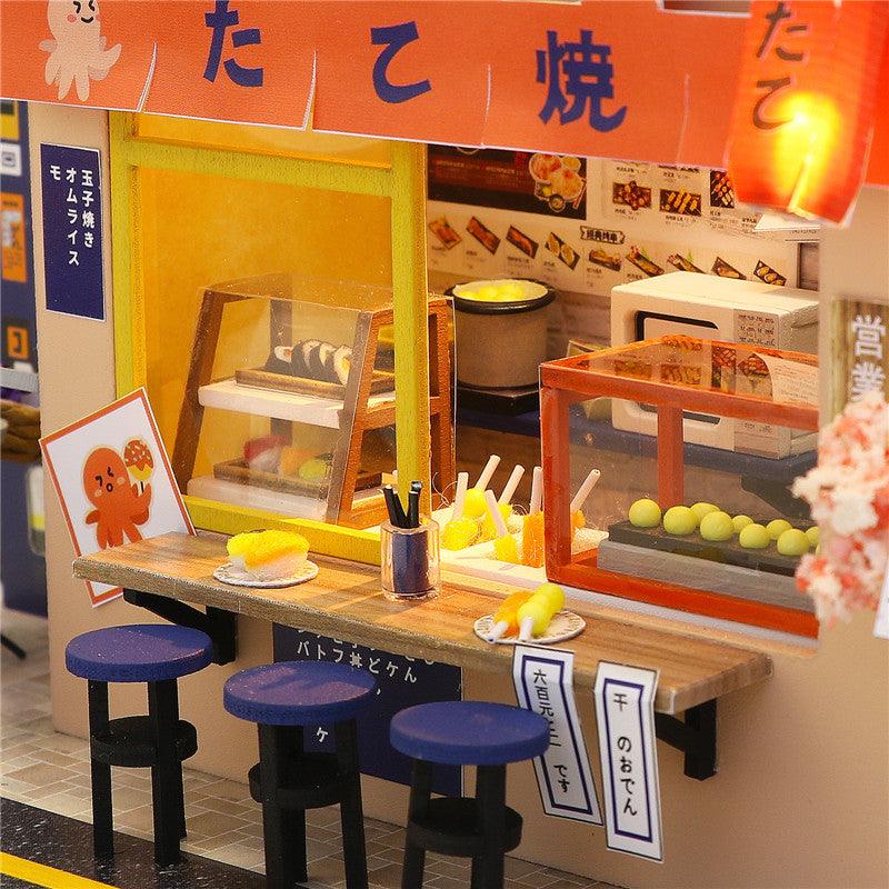 Takoyaki bar counter with octopus ball griddle and food display, a detailed miniature food shop build for shelf decor