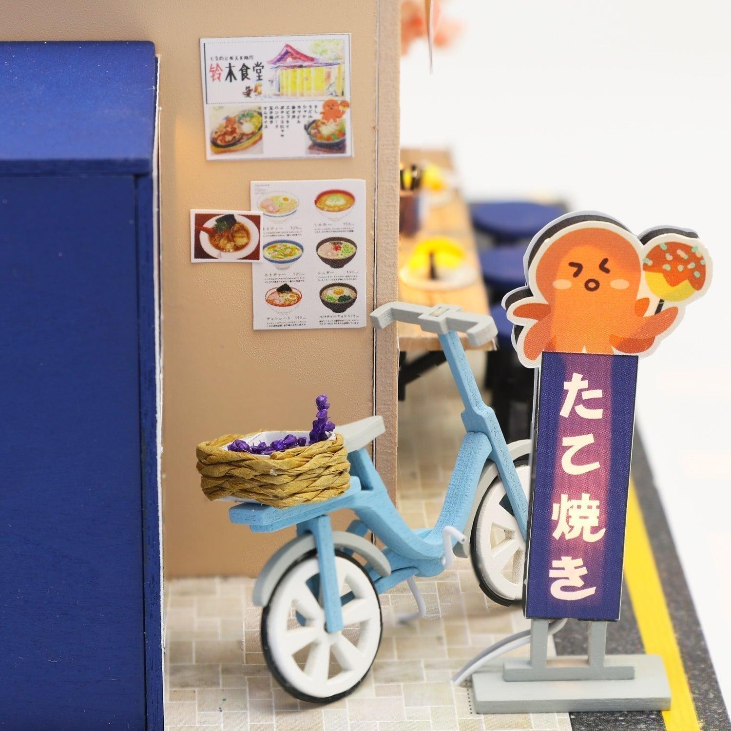 Glowing takoyaki street sign and blue bicycle in a LED lit Japanese dollhouse kit, desk decor gift for miniature fans