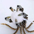 Illuminated steampunk octopus desk lamp glowing on a workspace, a mechanical metal model centerpiece for home decor