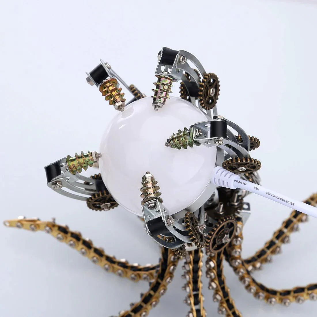 Illuminated steampunk octopus desk lamp glowing on a workspace, a mechanical metal model centerpiece for home decor