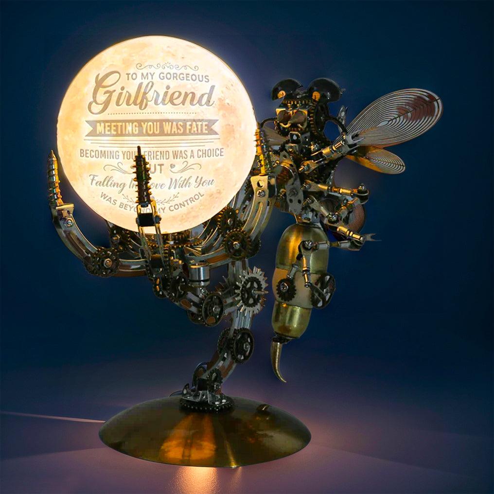 Laser cut metal wasp with industrial gears and rivets in steel and copper, mounted on the lit Jupiter light base