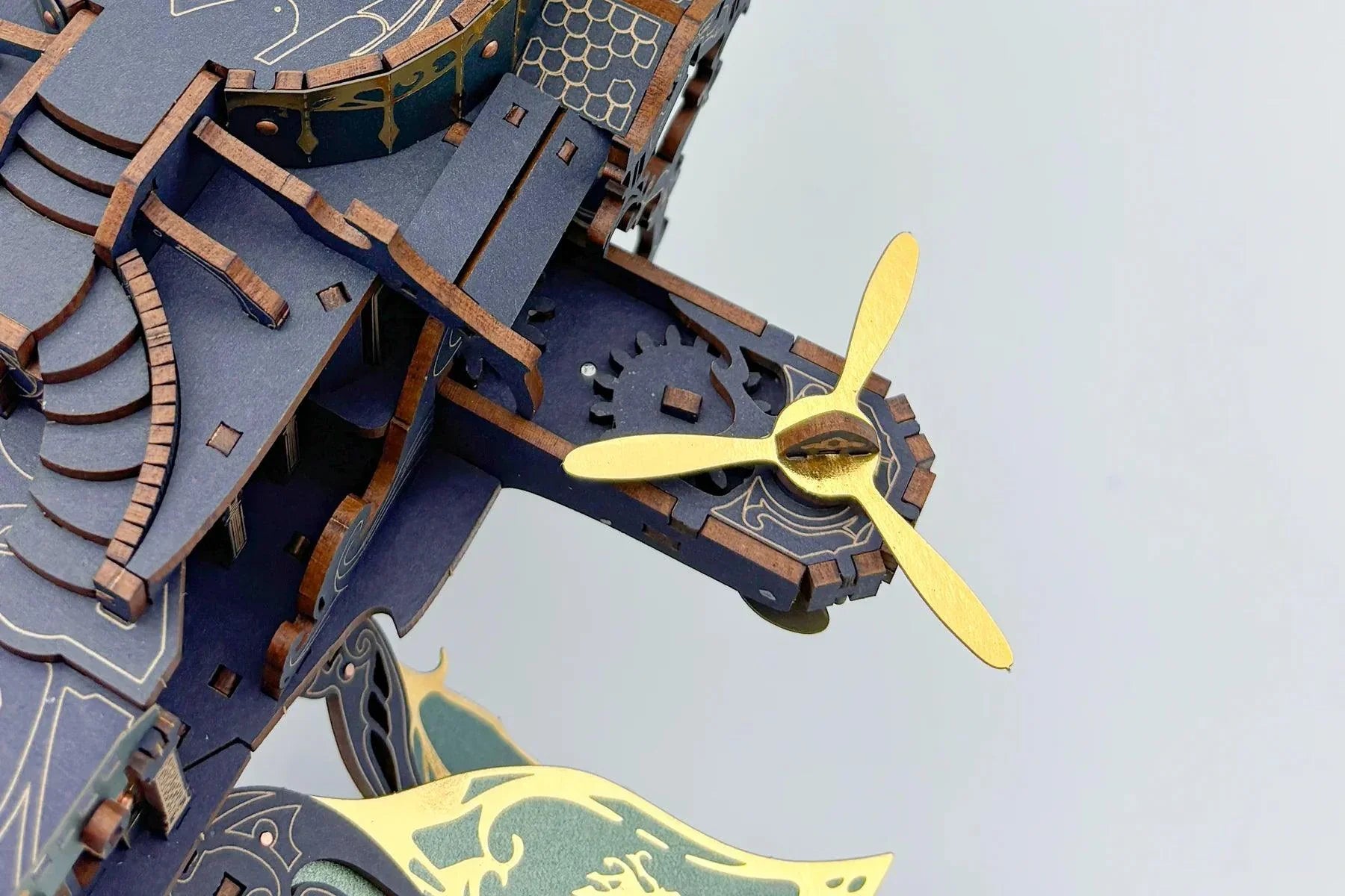 Carved gears and propeller fins of the wooden ship model, a moving parts 3D puzzle and hobby build for adults Blue