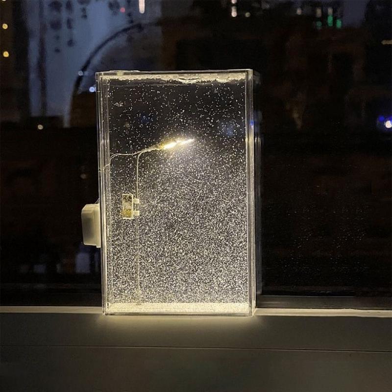 Illuminated winter desk lamp and shelf decoration with a tiny snow covered streetlight for a home office or dorm room