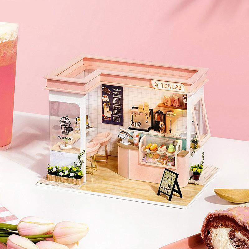 Kawaii bubble tea cafe diorama with a warm LED glow and tiny boba cups, a 1:24 miniature build for desk or shelf decor Pink