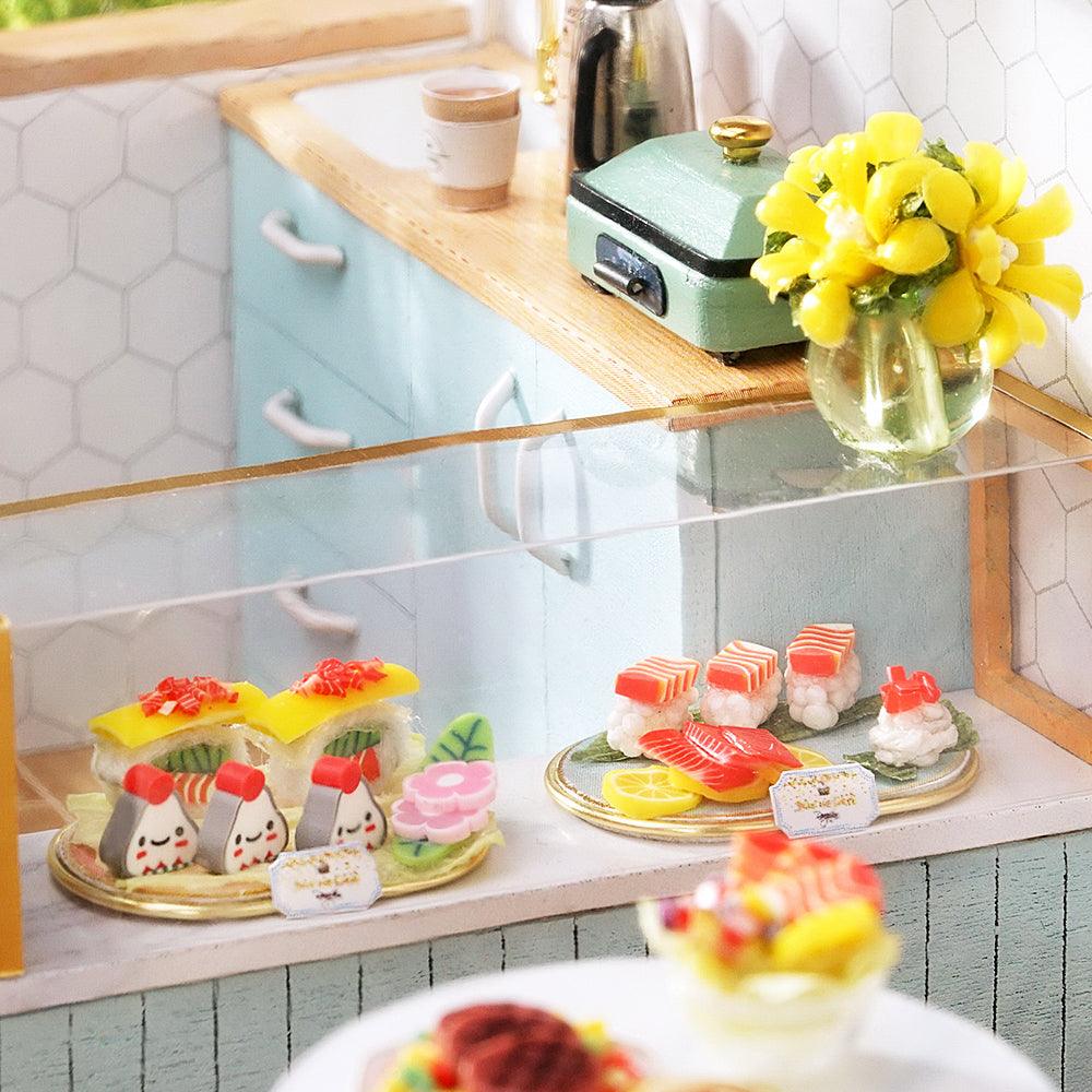 Tiny resin sushi and onigiri on a deli counter, a 1:24 miniature cafe dollhouse kit and hands-on build for ages 14 up Blue