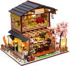 Miniature sushi restaurant dollhouse kit with warm LED lighting and a tiny Japanese sushi bar for adult crafters