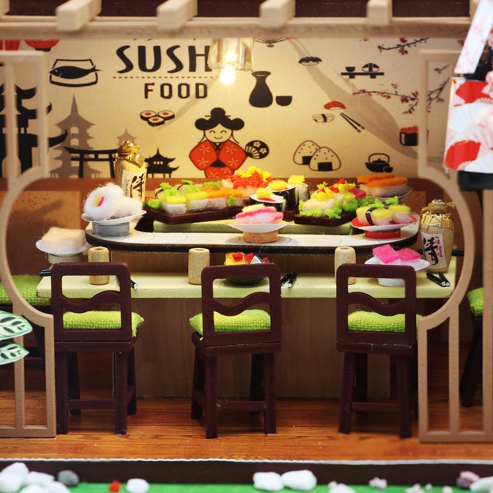 Handmade tiny sushi pieces and miniature dining furniture in a detailed 1:24 scale Japanese restaurant model kit