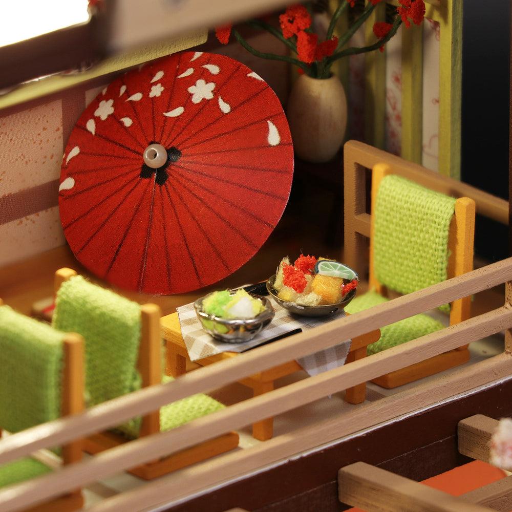 Miniature Japanese sushi bar with a music box and warm glowing lights to display as a finished tabletop scene