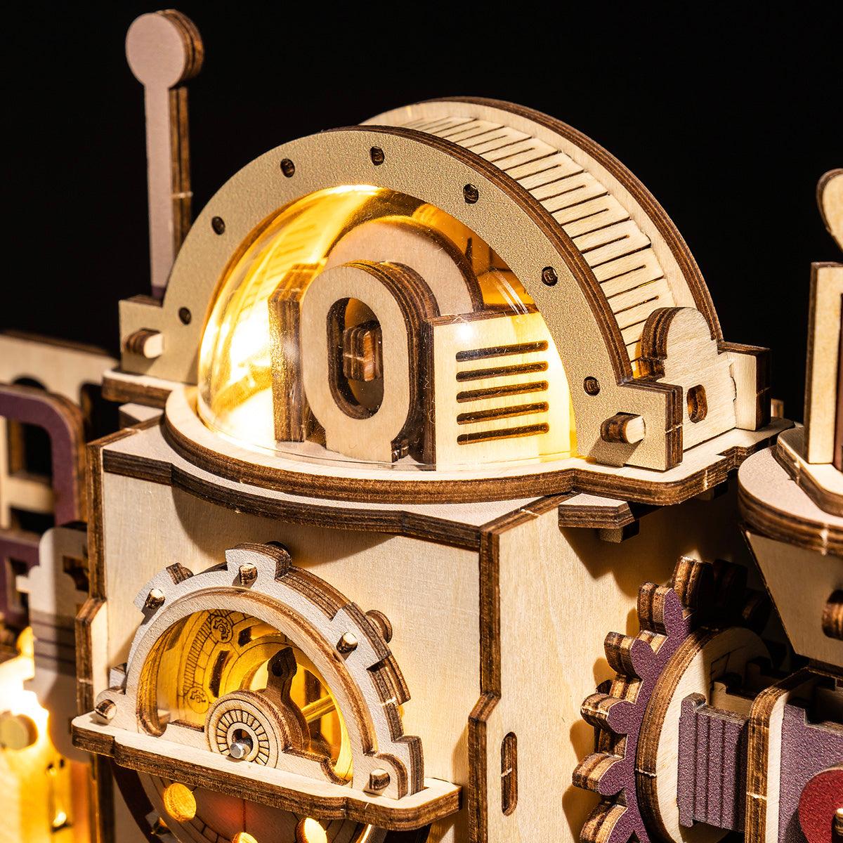 Wooden marble run kit with a lit dome and turning gears, a kinetic STEM building project for teenagers and adult hobbyists
