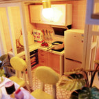 Detailed miniature kitchen with a fridge, oven and cookware, a warm 1:24 scale room box craft kit for hobby builders