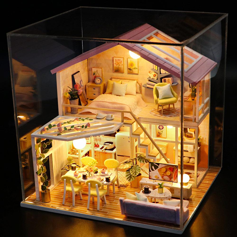 Finished miniature dollhouse under a clear dust cover case, a handmade LED lit room box for collectors and gifting