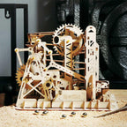 Wooden marble run with rotating gears and a crane elevator, a kinetic desk display and screen-free STEM build for teens