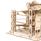 Assembled wooden marble run model kit with a flip-flop switch sending marbles down two separate pathways for STEM play