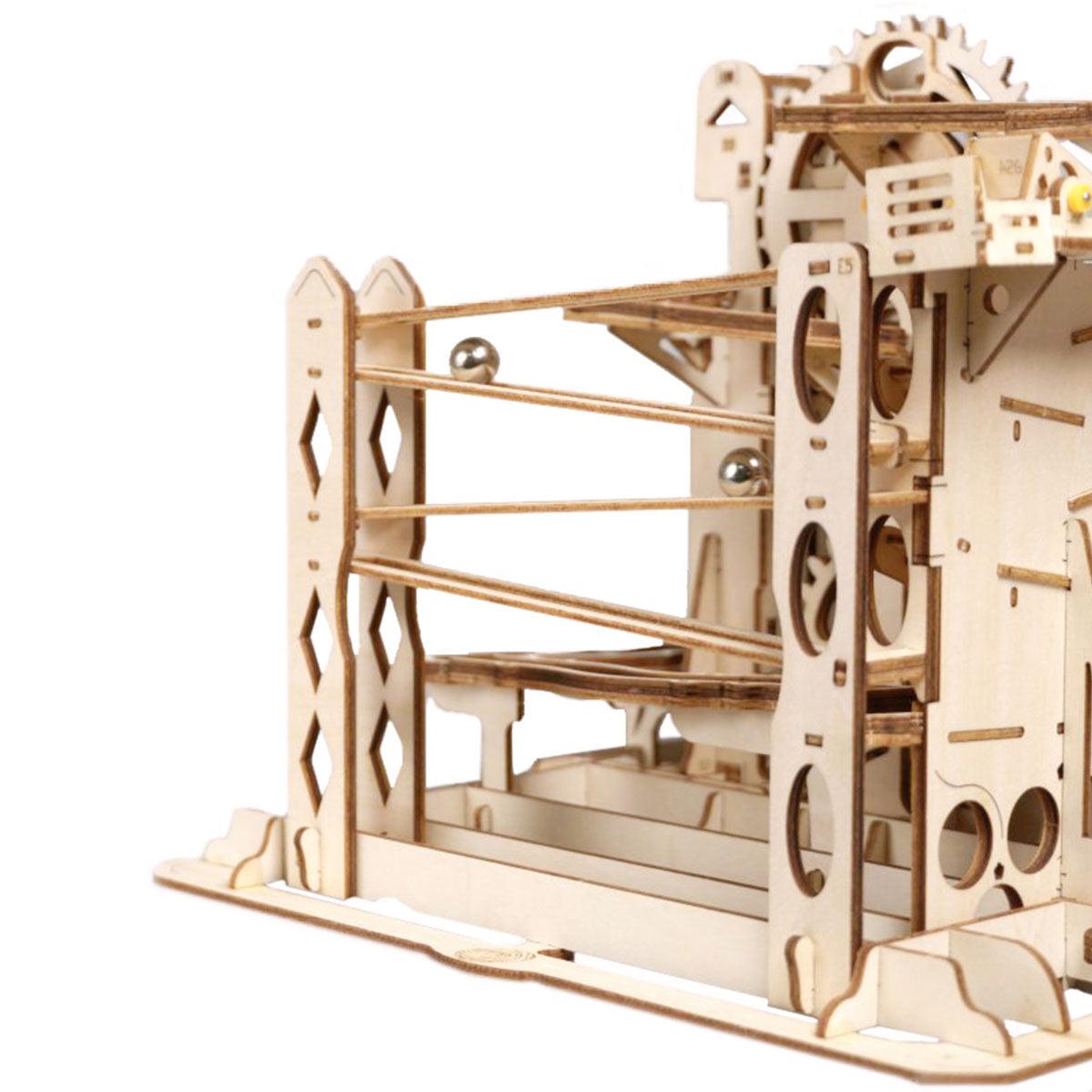 Assembled wooden marble run model kit with a flip-flop switch sending marbles down two separate pathways for STEM play