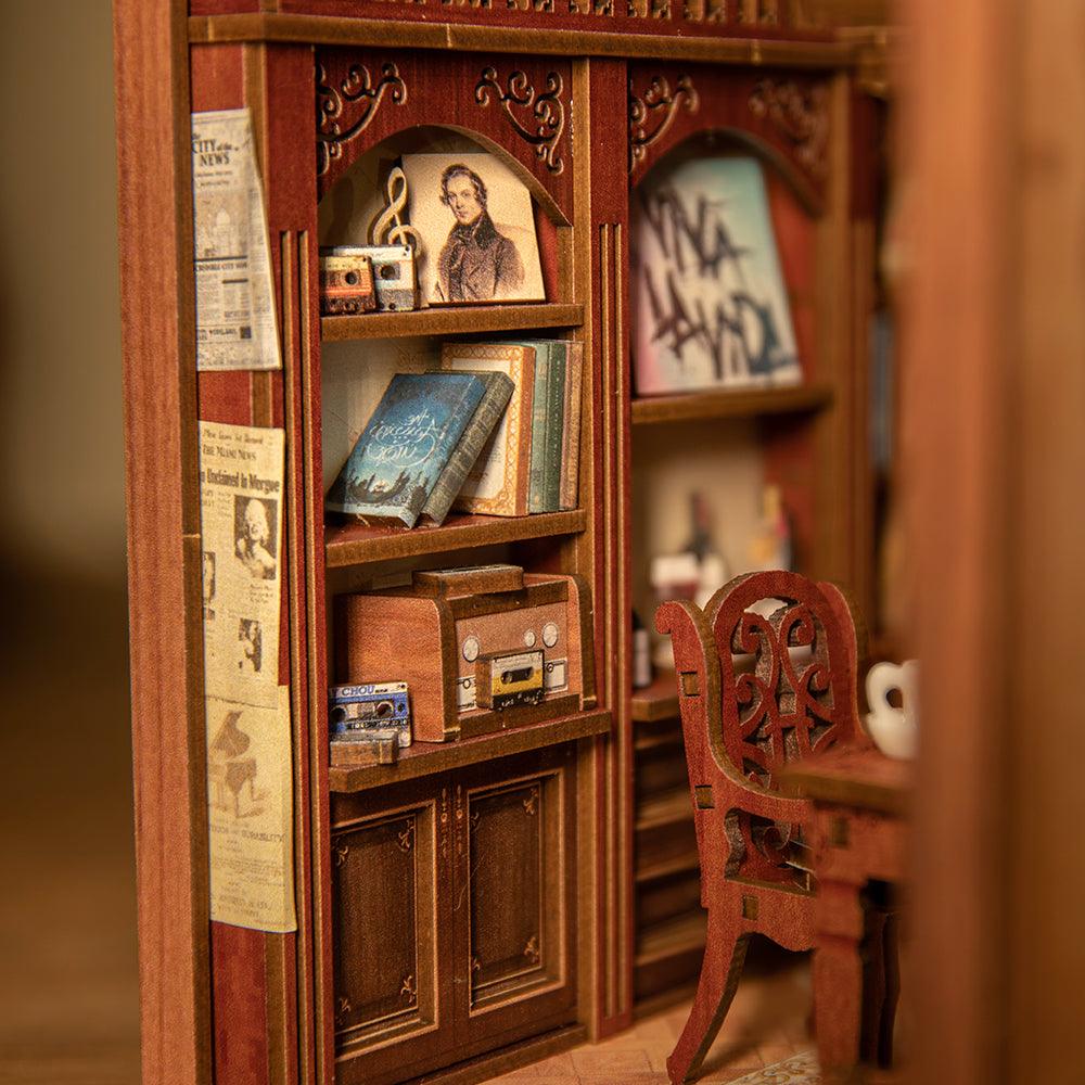 Miniature music room book nook interior with a tiny bookshelf, framed art, and chair for a lamplit shelf diorama SZ003