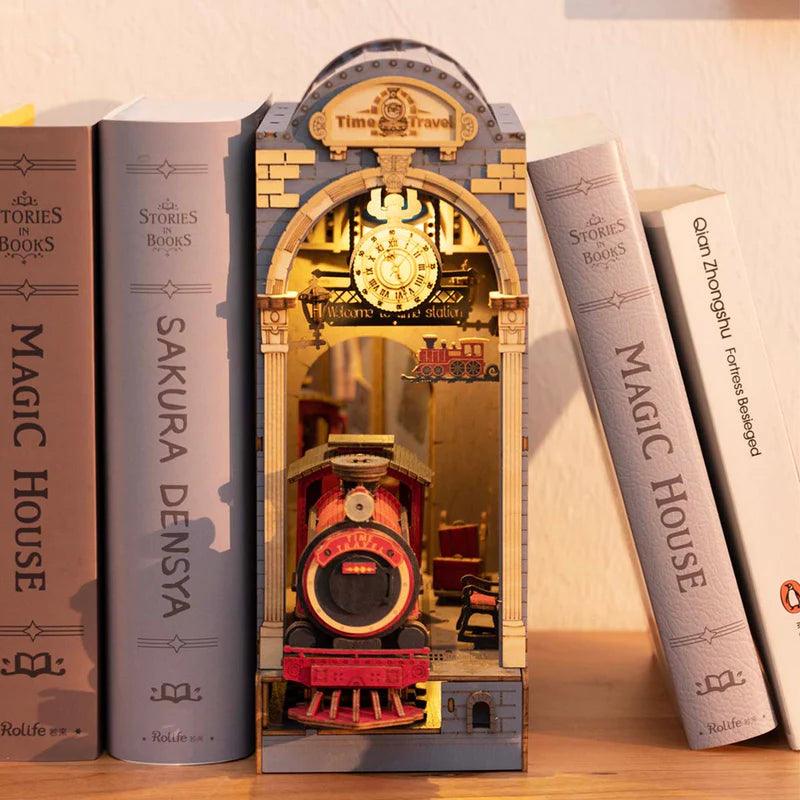 Warm LED train station book nook with a glowing pocket watch clock, a steampunk bookshelf insert for reading corners