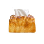 Realistic toast bread tissue box holder shaped like a golden loaf that turns a plain tissue box into quirky home decor