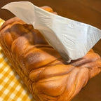 Golden loaf tissue holder that adds a coffee bar and bakery theme to a kitchen counter or breakfast nook setup