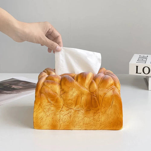 Novelty bread loaf tissue cover with an elastic lift that pushes each sheet up for easy one hand dispensing every day