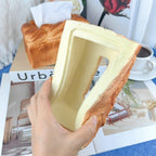 Toast bread tissue holder styled on a dining table with coffee and a magazine as a fun foodie decor accent for guests