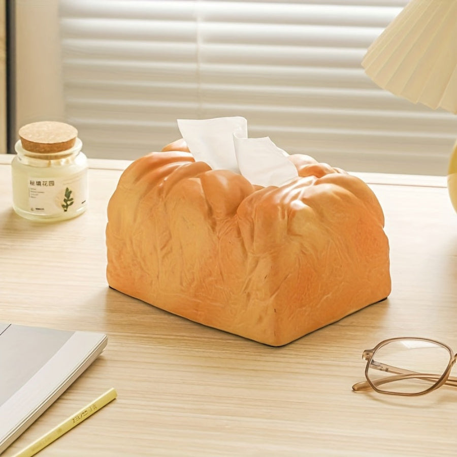 Golden toast tissue box holder on a work from home office desk as an offbeat accent beside a lamp and reading glasses