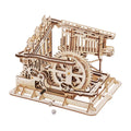 Trapdoor Tactician wooden marble run kit with 233 laser-cut pieces and 10 marbles, a build-it-yourself STEM machine