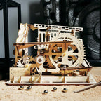 Marble run with turning gears and a wheel lifter raising marbles, a kinetic wooden model and STEM build for teens and adults