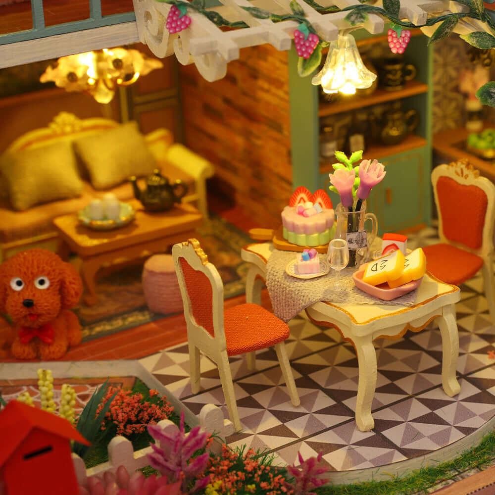 Cozy resort living and dining room with a golden sofa, tea set, dining table and a little poodle in a handmade miniature kit