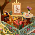 Rooftop balcony art studio with a tiny easel, paint palette and fresh flowers, a detailed miniature building kit for nature lovers