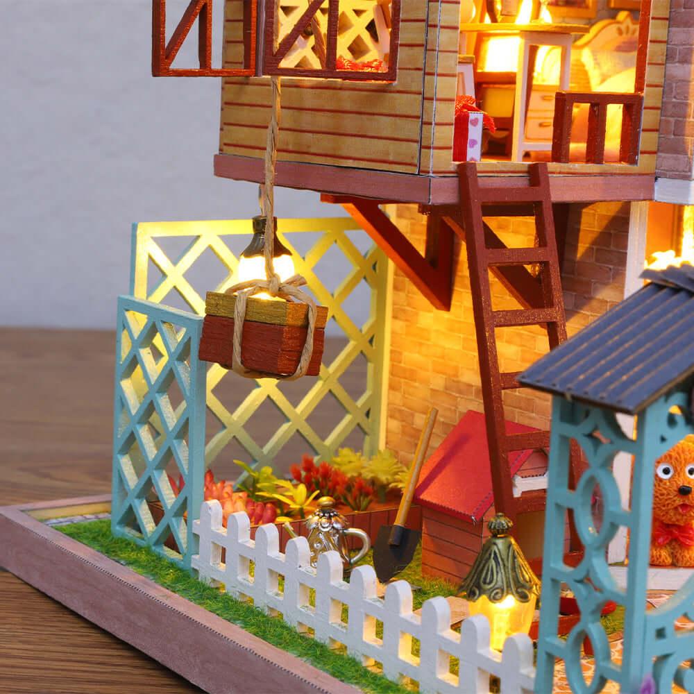 Brick resort facade with a wooden ladder, a glowing lantern lift and a fenced flower garden in an intricate miniature house kit
