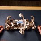 Wooden race car model with natural plywood grain and a smooth aerodynamic body, a 3D mechanical puzzle for adult hobbyists