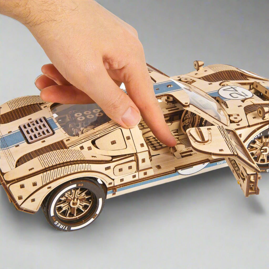 UGT-24 wooden model car styled as a classic endurance racer, an advanced 3D wooden puzzle and shelf display for car enthusiasts